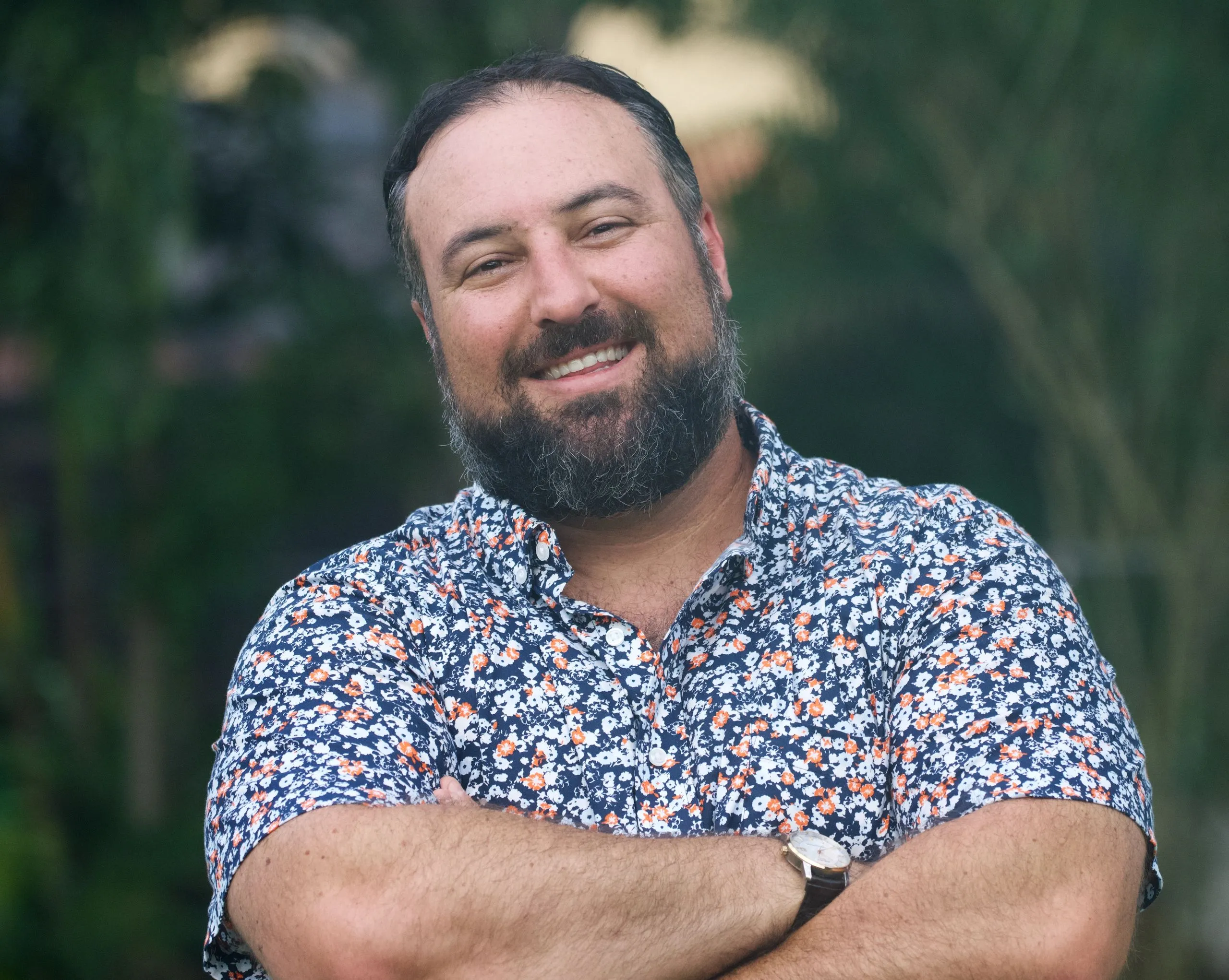 Hakim A. Lakhdar, smiling with arms crossed